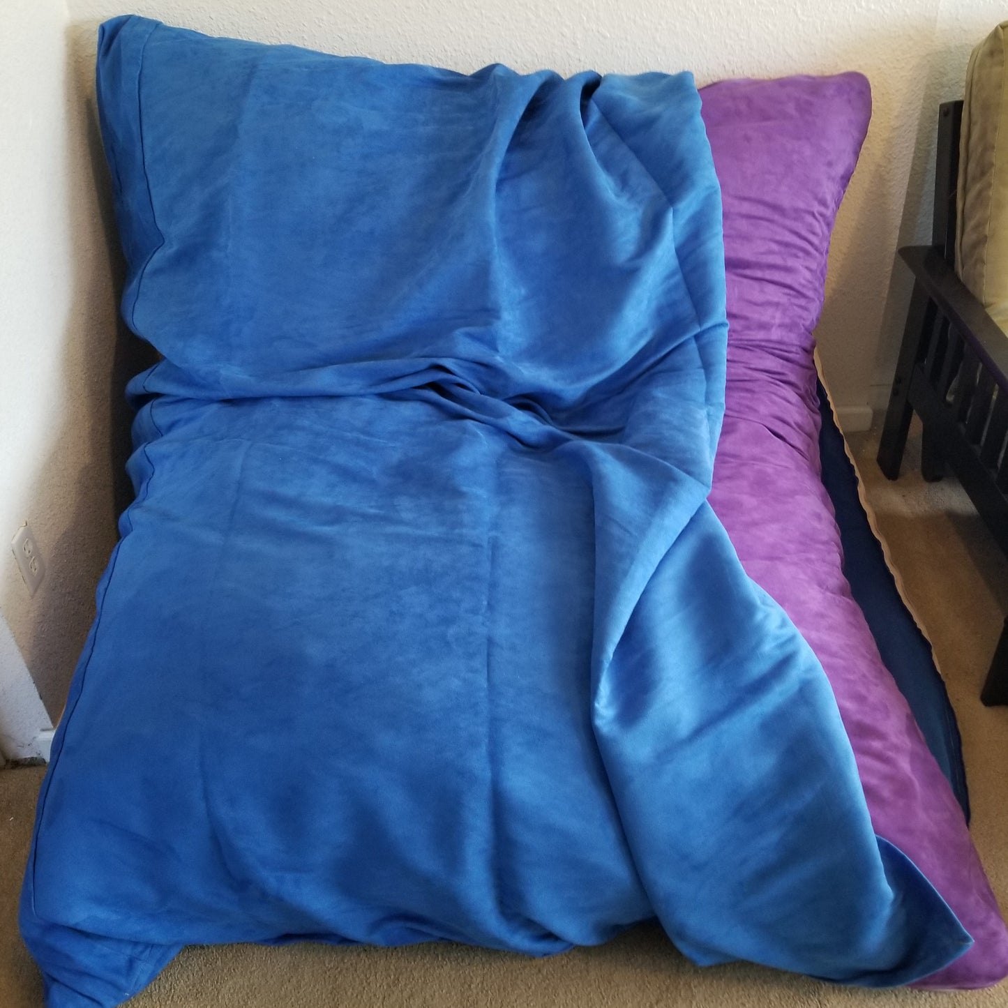 A Full Hug Bed & Crash Pad Shown With Cover Partially Removed